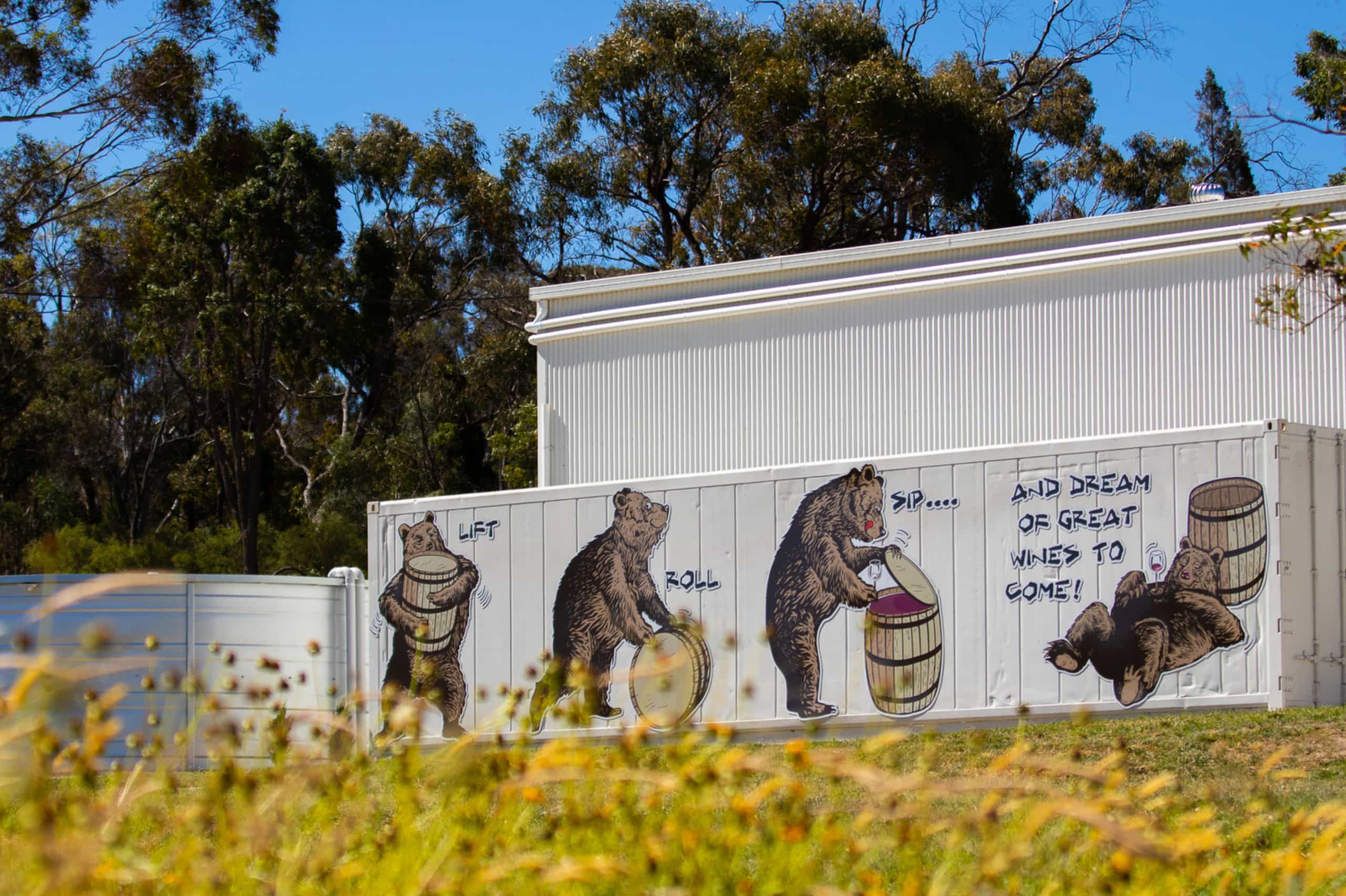 A shed at the Art of Krupinski vineyard and estate with a bear painted on the side