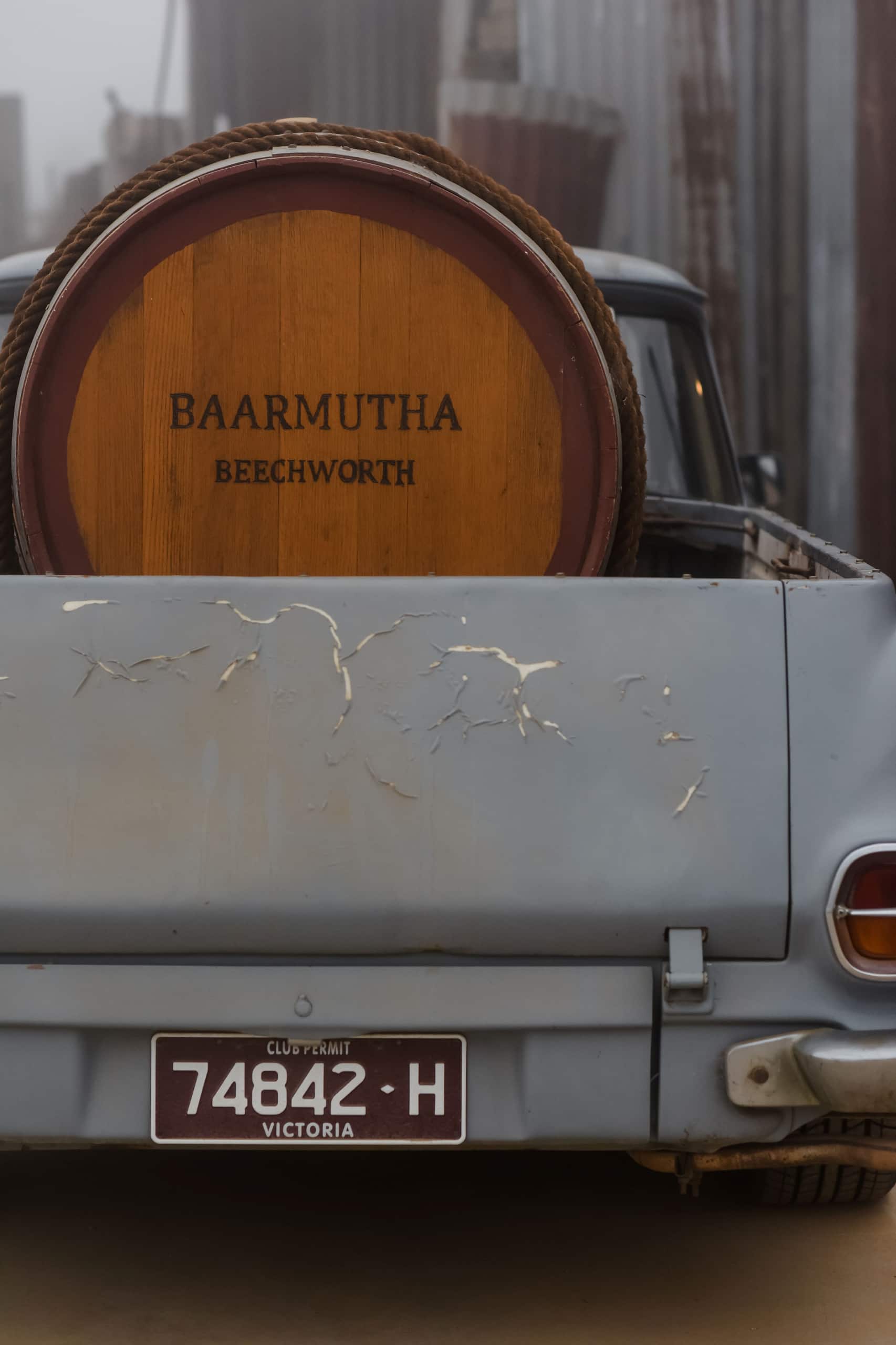 A wine barrel from Baarmutha Wines sitting in the back of a blue ute